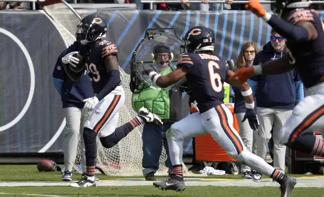 Chicago Bears cornerback Tyrique Stevenson (29) heads to the end zone for a touchdown after intercepting a pass by Tennessee Titans quarterback Will Levis during the second half of an NFL football game Sunday, Sept. 8, 2024, in Chicago. (AP Photo/Nam Y. Huh)