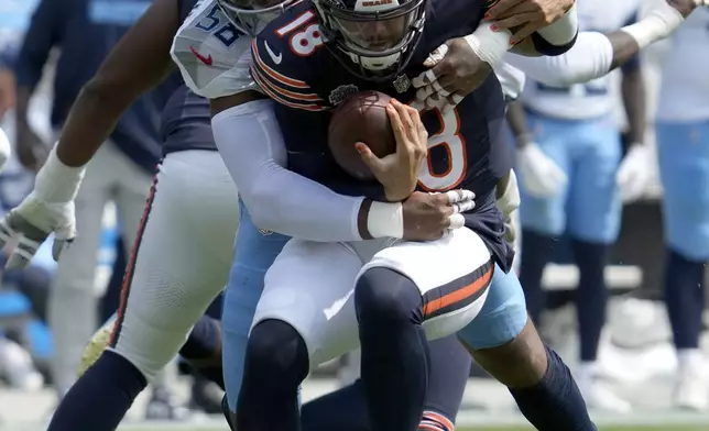 Tennessee Titans linebacker Harold Landry III, left, sacks Chicago Bears quarterback Caleb Williams during the second half of an NFL football game Sunday, Sept. 8, 2024, in Chicago. (AP Photo/Nam Y. Huh)