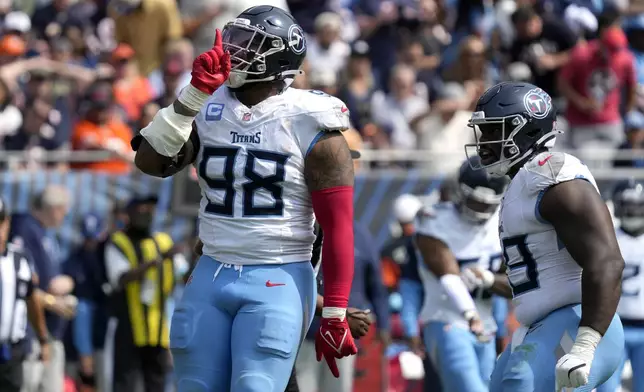 Tennessee Titans defensive tackle Jeffery Simmons gestures to the crowd after tackling Chicago Bears running back D'Andre Swift for a loss during the second half of an NFL football game Sunday, Sept. 8, 2024, in Chicago. (AP Photo/Nam Y. Huh)