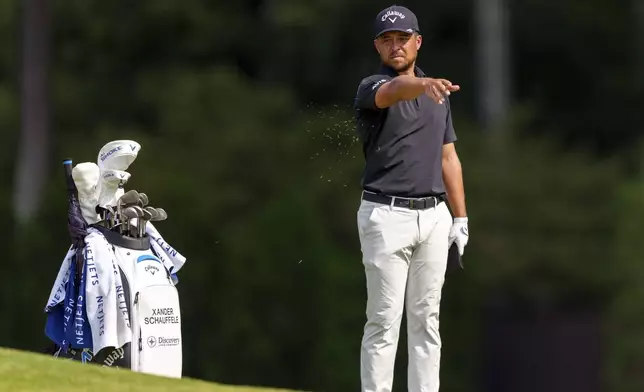 Xander Schauffele checks the wind from the fairway on the seventh hole during the third round of the Tour Championship golf tournament, Saturday, Aug. 31, 2024, in Atlanta. (AP Photo/Jason Allen)