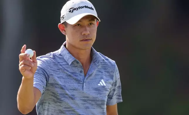 Collin Morikawa waves to the crowd after making his putt on eight during the third round of the Tour Championship golf tournament, Saturday, Aug. 31, 2024, in Atlanta. (AP Photo/Jason Allen)