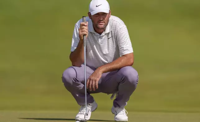 Scottie Scheffler prepares to putt on the seventh hole during the third round of the Tour Championship golf tournament, Saturday, Aug. 31, 2024, in Atlanta. (AP Photo/Jason Allen)