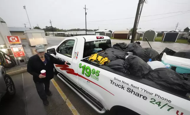 Pat Simon, a resident of Morgan City, stops at a gas station after loading up a rental truck with possessions from his home, as he evacuates to a hotel in anticipation of Hurricane Francine, in Morgan City, La., Wednesday, Sept. 11, 2024. (AP Photo/Gerald Herbert)