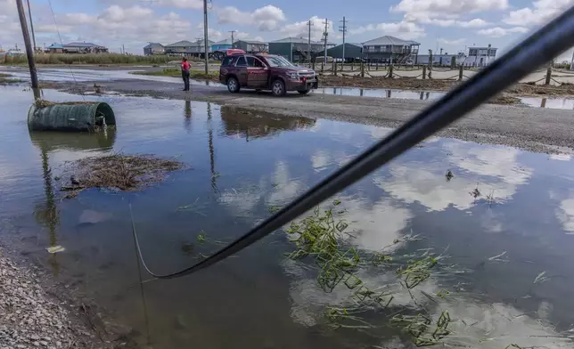 Little Caillou Fire Department staff survey the damage from Hurricane Francine at the end of Highway 57 in the southern most point of Terrebonne Parish, La., Thursday, Sept. 12, 2024. (Chris Granger/The Times-Picayune/The New Orleans Advocate via AP)