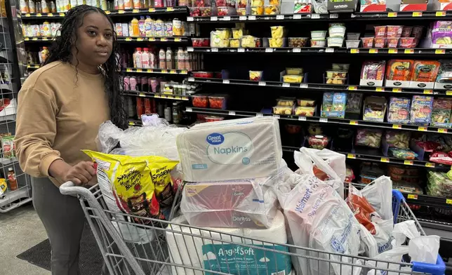 Roxanne Riley, 42, stocks up on supplies at a Walmart as she prepares to shelter in place in New Orleans as Tropical Storm Francine barrels toward the Louisiana coast, Tuesday, Sept. 10, 2024. (AP Photo/Jack Brook)