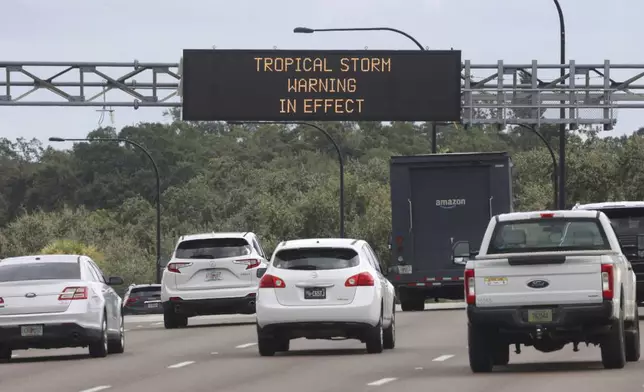 A traffic advisory sign on westbound S.R. 408 near downtown Orlando, Fla., informs commuters of the approaching Hurricane Helene, Wednesday, Sept. 25, 2024. (Joe Burbank/Orlando Sentinel via AP)