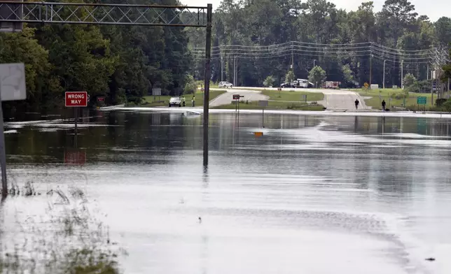 Flooding from heavy rains closed U.S Highway 17 near Winnabow, south of Wilmington, N.C., on Tuesday, Sept.17, 2024. (AP Photo/Chris Seward)