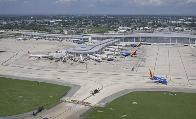 A pair of helicopters land at New Orleans International Airport following Hurricane Francine, Friday, Sept. 13, 2024, in Kenner, La. (Hilary Scheinuk/The Advocate via AP, Pool)