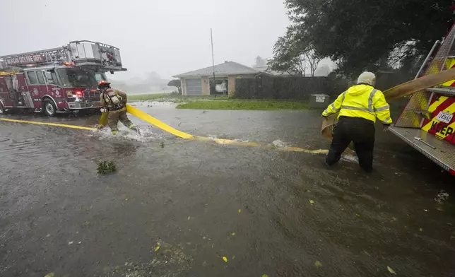 Morgan City firefighters respond to a home fire during Hurricane Francine in Morgan City, La., Wednesday, Sept. 11, 2024. (AP Photo/Gerald Herbert)