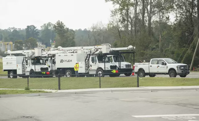 Crew members from Xylem Tree Experts gather at a staging area at Langley Pond Park in the aftermath of Hurricane Helene Sunday, Sept. 29, 2024, in Aiken, S.C. (AP Photo/Artie Walker Jr.)