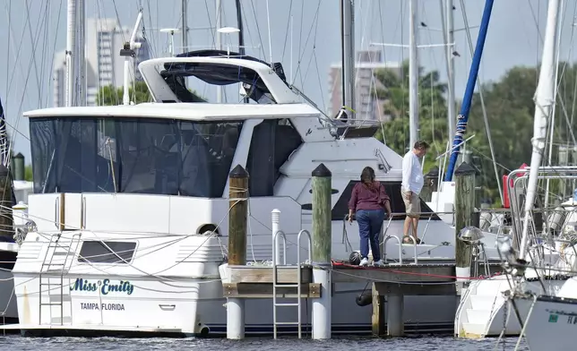 Owners secure their boats outside the Davis Islands Yacht Club Wednesday, Sept. 25, 2024, ahead of Hurricane Helene in Tampa, Fla. (AP Photo/Chris O'Meara)