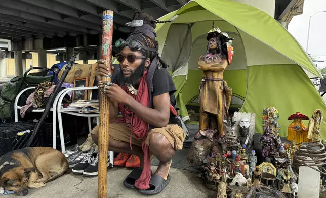 Ronell King, 32, unhoused, plans to hunker down in his tent under an overpass Tuesday, Sept. 10, 2024, in New Orleans, rather than go to an emergency shelter set up by the city in anticipation of Tropical Storm Francine. (AP Photo/Jack Brook)