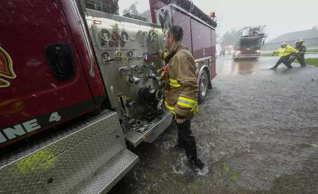 Morgan City firefighters respond to a home fire during Hurricane Francine in Morgan City, La., Wednesday, Sept. 11, 2024. (AP Photo/Gerald Herbert)