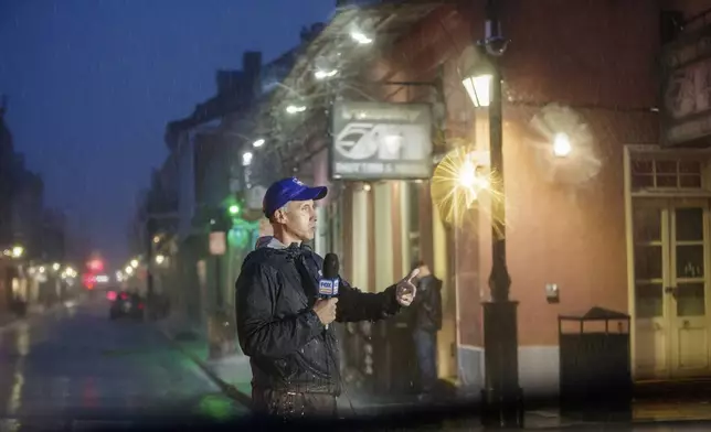 Fox Weather on-air talent Bob Van Dillen reports on Hurricane Francine from Bourbon Street in New Orleans, Wednesday, Sept. 11, 2024. (David Grunfeld/The Times-Picayune/The New Orleans Advocate via AP)