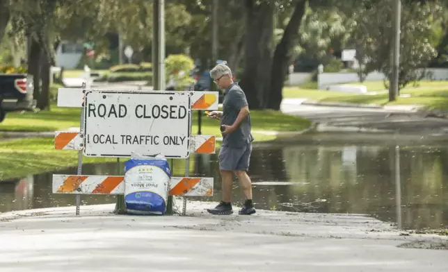 A sign closing down a road is posted around the Sunset Park neighborhood as Hurricane Helene makes its way toward the Florida panhandle on Thursday, Sept. 26, 2024, in Tampa, Fla. (Jefferee Woo/Tampa Bay Times via AP)