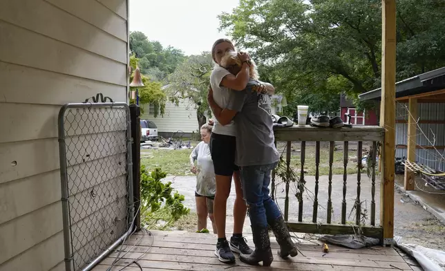 Ashlie Salliotte, left, hugs Janet Sams, right, at Sams' flood-damaged home along River Road, in the aftermath of Hurricane Helene, Saturday, Sept. 28, 2024, in Newport, Tenn. (AP Photo/George Walker IV)