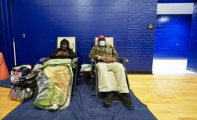 Mary Tanner Jerome Tanner, of Tallahassee, sit inside an evacuation shelter ahead of Hurricane Helene, expected to make landfall here today, in Leon County, Fla., Thursday, Sept. 26, 2024. (AP Photo/Gerald Herbert)