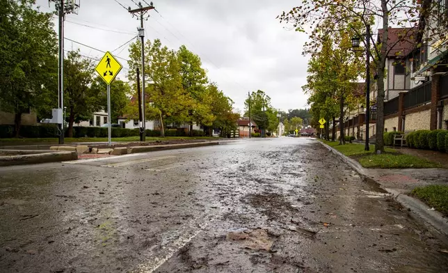 Debris litters Hendersonville Road in Historic Biltmore Village in Asheville, N.C. on Friday, Sept. 27, 2024. (Josh Bell/The Asheville Citizen-Times via AP)