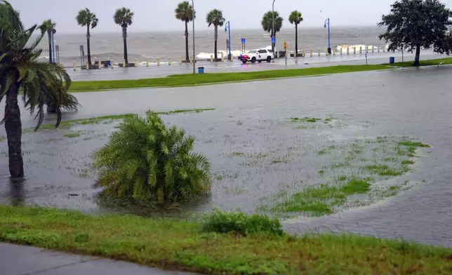 Orleans Levee District Police patrol Lakeshore Drive along Lake Ponchartrain as wind and rain pick up from Hurricane Francine in New Orleans, Wednesday, Sept. 11, 2024. (AP Photo/Matthew Hinton)