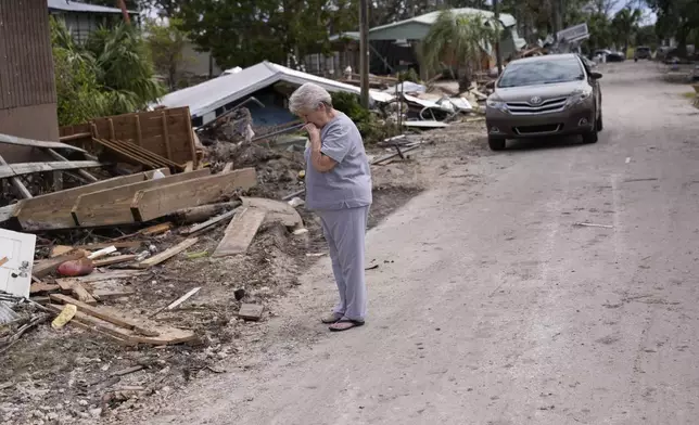 Elsie Hicks looks at the destruction of the home she has lived in for 25 years, in the aftermath of Hurricane Helene, in Horseshoe Beach, Fla., Saturday, Sept. 28, 2024. (AP Photo/Gerald Herbert)