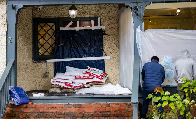 Bette Boutique employees prepare their store for Hurricane Helene in Historic Biltmore Village in Asheville, N.C. on Friday, Sept. 27, 2024. (Josh Bell/The Asheville Citizen-Times via AP)