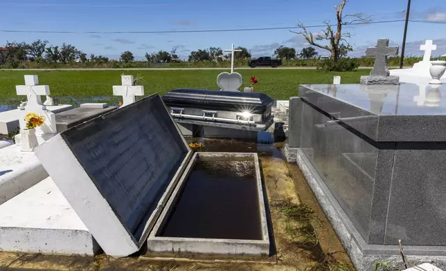 A casket floated out of the ground at a cemetery from waters brought on by Hurricane Francine, Thursday, Sept. 12, 2024, in Terrebonne Parish, La. (Chris Granger/The Times-Picayune/The New Orleans Advocate via AP)