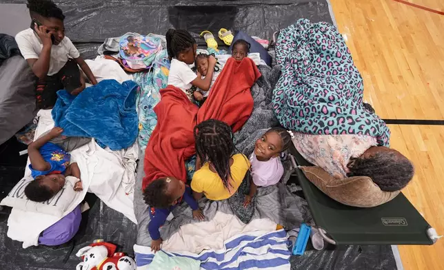 Vera Kelly, of Tallahassee, lies on a cot after evacuating to a hurricane shelter with her grandchildren and great grandchildren, at Fairview Middle School, ahead of Hurricane Helene, expected to make landfall here today, in Leon County, Fla., Thursday, Sept. 26, 2024. (AP Photo/Gerald Herbert)