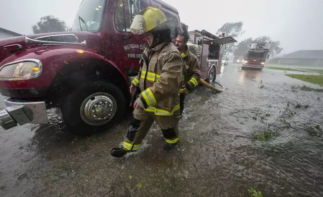 Morgan City firefighters respond to a home fire during Hurricane Francine in Morgan City, La., Wednesday, Sept. 11, 2024. (AP Photo/Gerald Herbert)