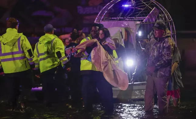 An airboat transports residents rescued from floodwaters in the aftermath of Hurricane Helene on Friday, Sept. 27, 2024 in Crystal River, Fla. (Luis Santana/Tampa Bay Times via AP)