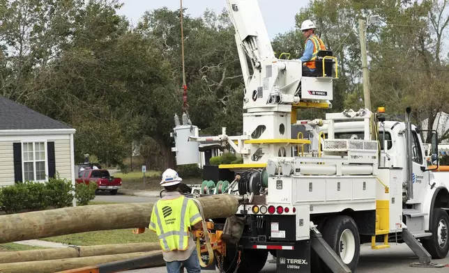 Dominion Energy team members unload a transformer in the aftermath of Hurricane Helene Sunday, Sept. 29, 2024, in North Augusta, S.C. (AP Photo/Artie Walker Jr.)