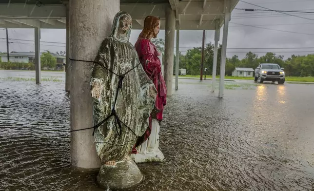 Hurricane Francine floodwater rises around a statue of Mary tied to the support of an elevated home in Terrebonne Parish as the hurricane begins to make landfall along the Louisiana coast on Wednesday, Sept.11, 2024. (Chris Granger/The Times-Picayune/The New Orleans Advocate via AP)