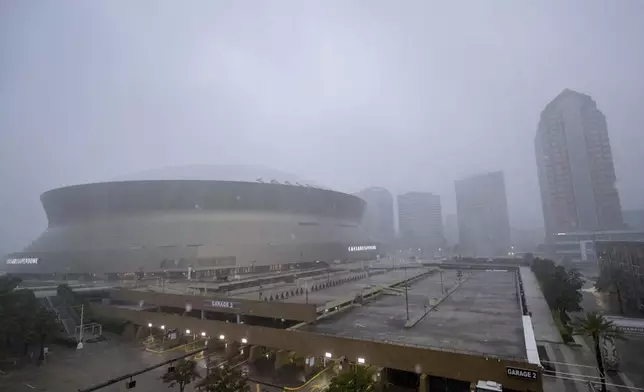 Rainfall from Hurricane Francine makes the white roof of the Caesars Superdome, left, difficult to see in New Orleans, Wednesday, Sept. 11, 2024. (AP Photo/Matthew Hinton)