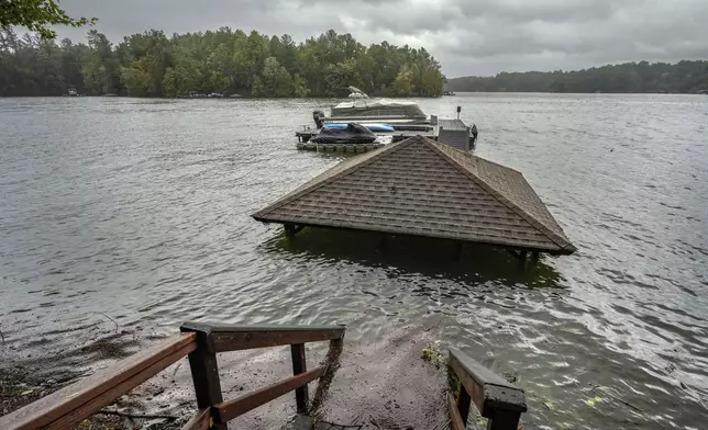 Torrential rain from Hurricane Helene has caused lake levels to rise on Lake James, resulting in flooded docks and gazebos, Friday, Sept. 27, 2024 in Morganton, N.C. (AP Photo/Kathy Kmonicek)