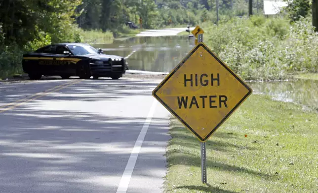 Flooding closes part of Stone Chimney Road in Supply, N.C., Tuesday, Sept. 17, 2024. (AP Photo/Chris Seward)