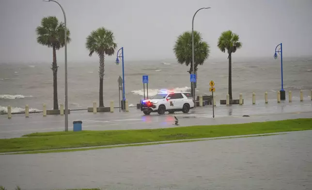 Orleans Levee District Police patrol Lakeshore Drive along Lake Ponchartrain as wind and rain pick up from Hurricane Francine in New Orleans, Wednesday, Sept. 11, 2024. (AP Photo/Matthew Hinton)