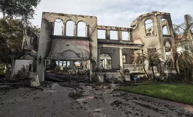 The remains of a home on Davis Island that burned during Hurricane Helene on Saturday, Sept. 28, 2024, in Tampa, Fla. (AP Photo/Mike Carlson)