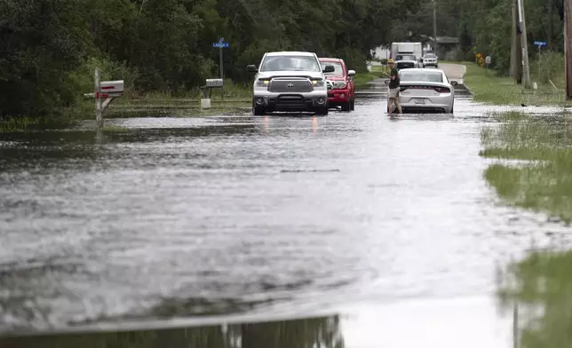 A motorist gets stuck in flood waters along Kiln-Waveland Cutoff Road in the Shoreline Park neighborhood in Hancock County, Miss., after Hurricane Francine on Thursday, Sept. 12, 2024. (Hannah Ruhoff/The Sun Herald via AP)