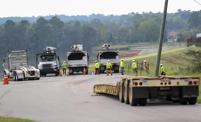 Crew members from Xylem Tree Experts arrive at a staging area at Langley Pond Park in the aftermath of Hurricane Helene Sunday, Sept. 29, 2024, in Aiken, S.C. (AP Photo/Artie Walker Jr.)