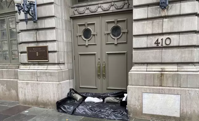 Sandbags and plastic line the threshold of an entrance to the the Williams Research Center in New Orleans' French Quarter, Wednesday, Sept. 11, 2024, as the city was bracing for high winds and possible flooding from as Hurricane Francine approached Louisiana's coast. (AP Photo/Kevin McGill)