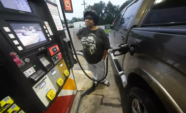 Wanda Presa, of Amelia, La., fills her truck with gas ahead of Hurricane Francine, in Morgan City, La., Wednesday, Sept. 11, 2024. (AP Photo/Gerald Herbert)