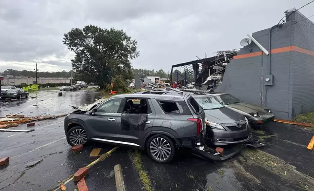 In this photo provided by the City of Rocky Mount, debris and smashed vehicles are scattered across a parking lot near Hing Ta Restaurant after a tornado hit Rocky Mount, N.C., Friday, Sept. 27, 2024. (City of Rocky Mount via AP)