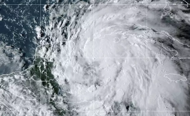 This National Oceanic and Atmospheric Administration satellite image taken at 6:10pm ET shows Tropical Storm Helene off the Gulf Coast of Florida near Mexico and Cuba on Tuesday, Sept. 24, 2024. (NOAA via AP)