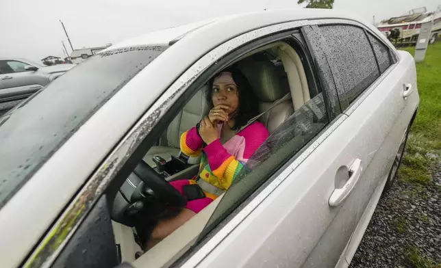 Melanie Favila talks about the impending Hurricane Francine after she returned to her trailer to retrieve important documents at a trailer park, in Morgan City, La., Wednesday, Sept. 11, 2024. She will be staying with family in a house in central Morgan City. (AP Photo/Gerald Herbert)