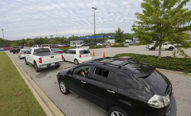 Residents wait in line for gas at Sam's Club in the aftermath of Hurricane Helene Sunday, Sept. 29, 2024, in Aiken, S.C. (AP Photo/Artie Walker Jr.)