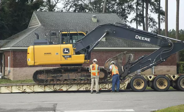 Dominion Energy team members load up heavy equipment at a staging area at Langley Pond Park in the aftermath of Hurricane Helene Sunday, Sept. 29, 2024, in Aiken, S.C. (AP Photo/Artie Walker Jr.)