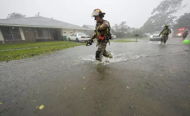 Morgan City firefighters respond to a home fire during Hurricane Francine in Morgan City, La., Wednesday, Sept. 11, 2024. (AP Photo/Gerald Herbert)