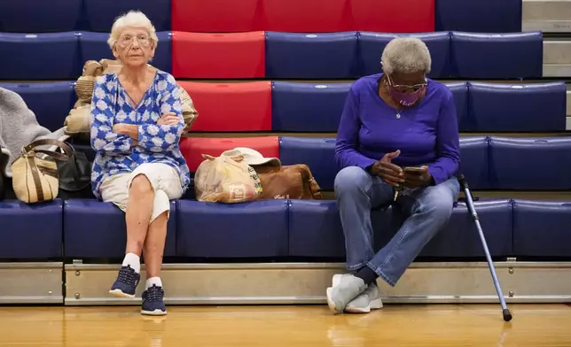 Jean McCloud, left, and Bernice Walker, both of Tallahassee, sit inside a hurricane evacuation shelter at Fairview Middle School, ahead of Hurricane Helene, expected to make landfall here today, in Leon County, Fla., Thursday, Sept. 26, 2024. (AP Photo/Gerald Herbert)