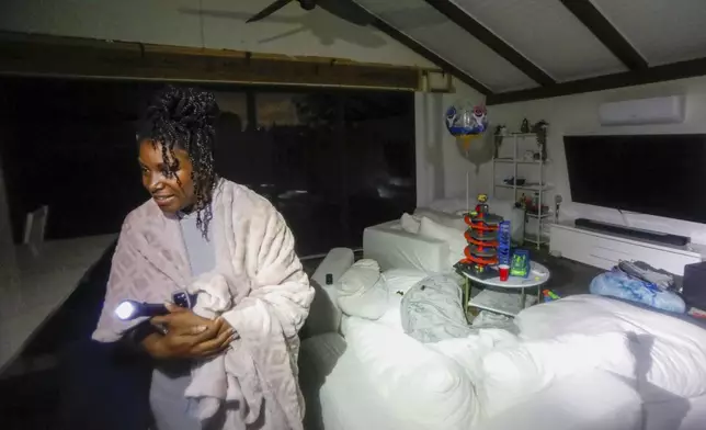 Clarissa Lucky gives a tour of her home that flooded from Hurricane Helene near DeSoto Park, Fla., on Friday, Sept. 27, 2024, in Tampa. (Jefferee Woo/Tampa Bay Times via AP)