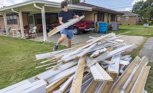 Gavin Hinchman with Precision One Construction Group carefully steps around water-damaged doors and walls as he guts part of a flooded home in Norco, La., on Friday, Sept. 13, 2024, two days after Hurricane Francine swept through the area. (Chris Granger/The Times-Picayune/The New Orleans Advocate via AP)