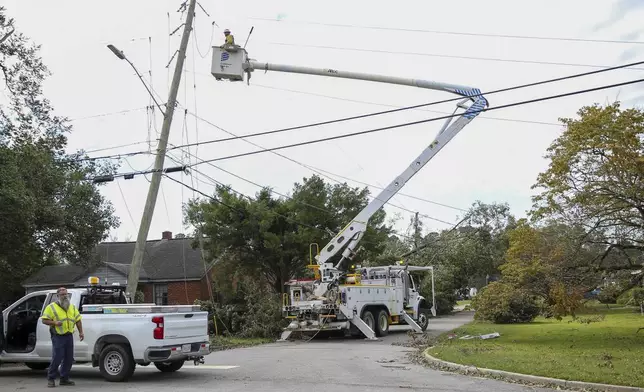 A Dominion Energy lineman works on a power line in the aftermath of Hurricane Helene Sunday, Sept. 29, 2024, in North Augusta, S.C. (AP Photo/Artie Walker Jr.)